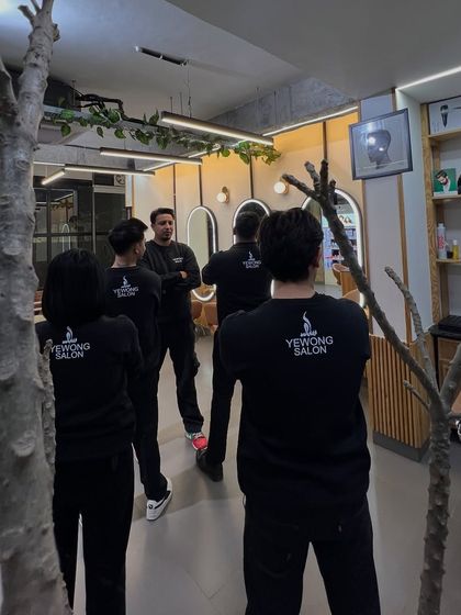 A team huddle at the salon. We believe in continuous education and teamwork to stay inspired.