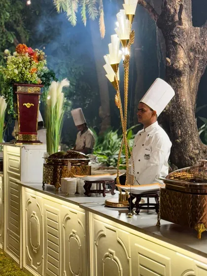 A wide shot of one of my elegant buffet setups at an outdoor wedding. The professional staff, high quality serveware, and beautiful decor all come together to create an unforgettable dining experience.