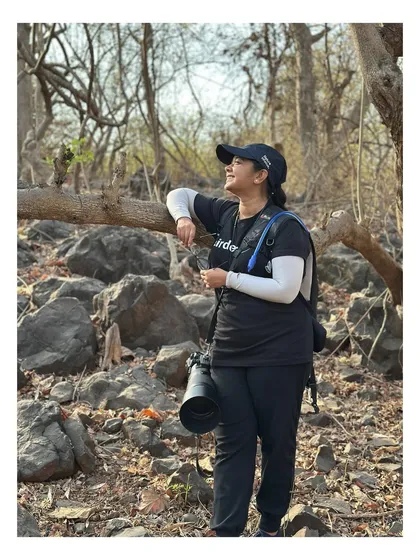 A full-length shot showing all the gear. Photography in the wild requires not just a good camera, but also being prepared for long treks and changing conditions.