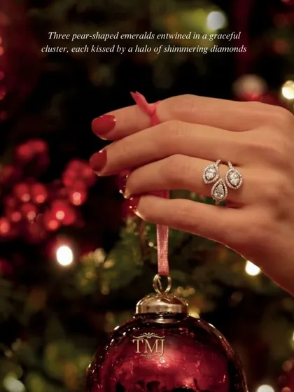 A quiet statement, made threefold. This unique ring features three pear-shaped emeralds entwined in a graceful cluster, each surrounded by a halo of shimmering diamonds for a look of sophisticated sparkle.
