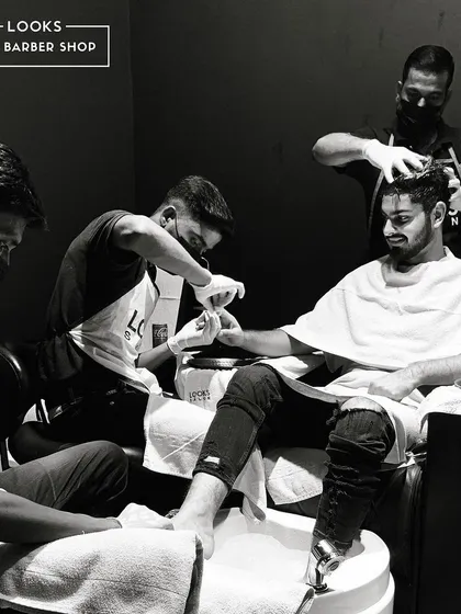 This is more than a facial, it's a full reset. This image captures the ultimate pamper session, where our client enjoys a manicure, pedicure, and hair treatment simultaneously. We are your one-stop shop for complete self-care.