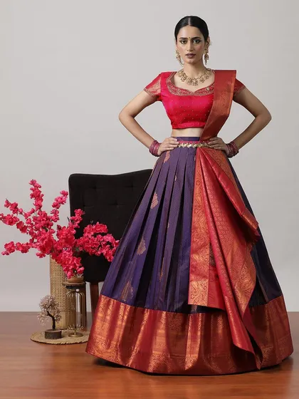 A deep purple and red half-saree lehenga, a bold and beautiful choice for any celebration.