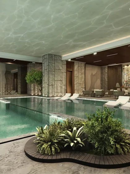 The expansive pool and lounge at Ceejay Residency's elite clubhouse. With striking rock cladding, soft lighting, and verdant greenery, the visual appeal is enhanced to integrate a sense of serene exclusivity.