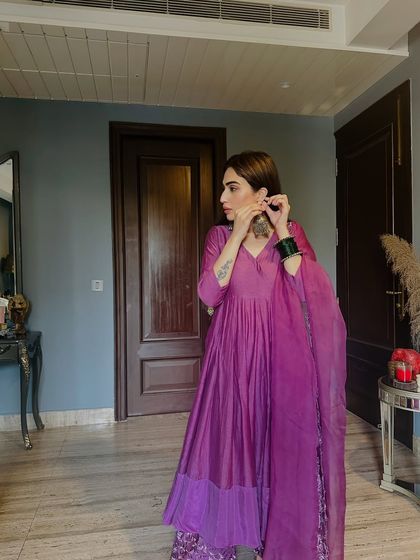 Getting ready in a gorgeous purple Anarkali suit. I’m pairing it with heavy silver-look jhumkas to complement the traditional silhouette.