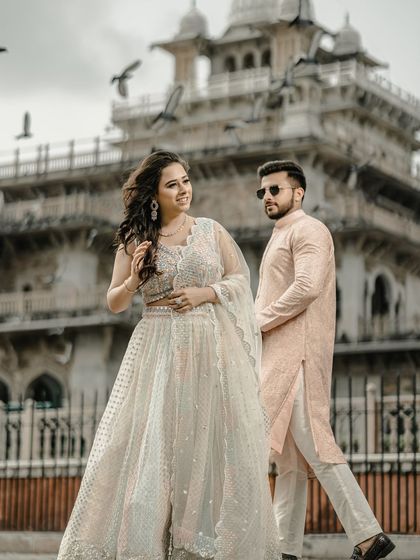 A stylish portrait in front of the Albert Hall Museum. The candid, walking pose gives the image a natural and unposed feel, capturing the couple's effortless style.