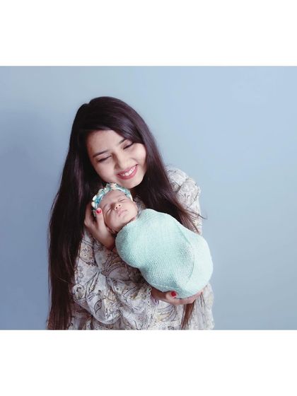 A candid moment of a mother smiling down at her sleeping baby. These unposed, natural interactions often make for the most beautiful photographs.