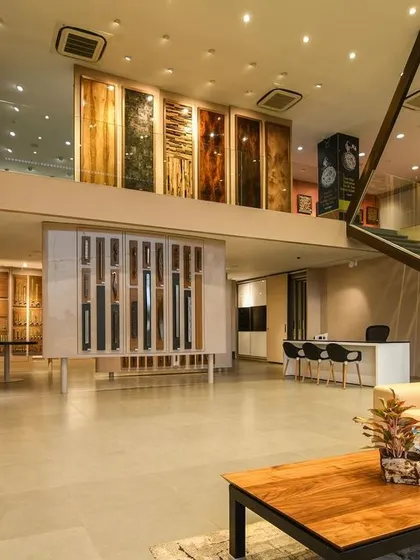 A comprehensive look at a conventional commercial space, highlighting the double-height reception, glass-walled mezzanine, and various product display areas designed for a modern business.