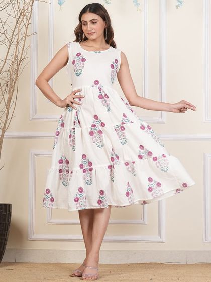 A side view of the white floral tiered dress, showing the flattering silhouette.