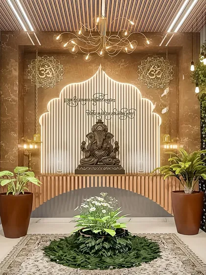 We designed this contemporary pooja space to be both serene and stylish. The design features a custom arch with LED backlighting against a fluted wood panel, a modern chandelier, and strategically placed plants to create a tranquil, nature-inspired ambiance for a Ganesha idol.