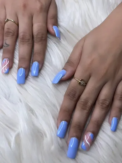 Square-shaped extensions in a lovely periwinkle blue, with an abstract swirl accent nail in pink and white for a pop of contrast.