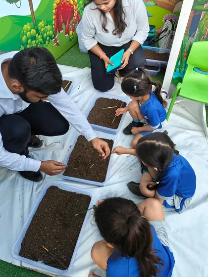 Our instructors provide guidance every step of the way. Here, we're helping young paleontologists carefully excavate 'fossils' in our dinosaur dig activity.