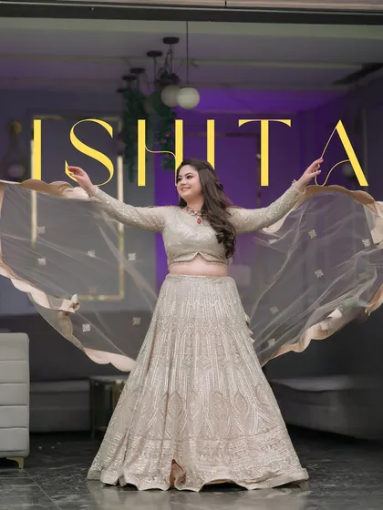 A joyful shot of the bride, Ishita, with her dupatta flowing, capturing her happiness and the elegance of her lehenga.