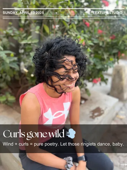 Curls gone wild in the wind. There's nothing like seeing natural, healthy curls dance freely. This is pure poetry in motion.