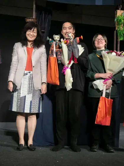 The team from Taiwan's 'Hiss & Arf' receives flowers and applause. We ensure that every international troupe feels welcomed and appreciated for bringing their unique stories to our stage.