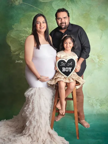 The whole family is excited to welcome a baby boy. Including older siblings and announcement props makes for such a joyful and complete family maternity portrait.