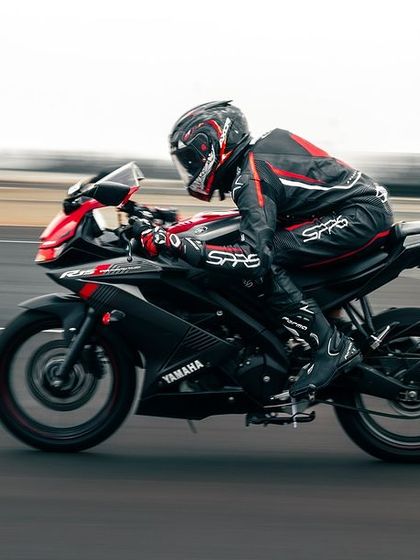 A rider on a Yamaha R15 on the track.