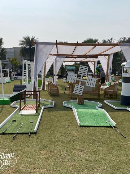 A mini-golf course I set up for a sports-themed party, complete with fun obstacles like a windmill and a lighthouse.
