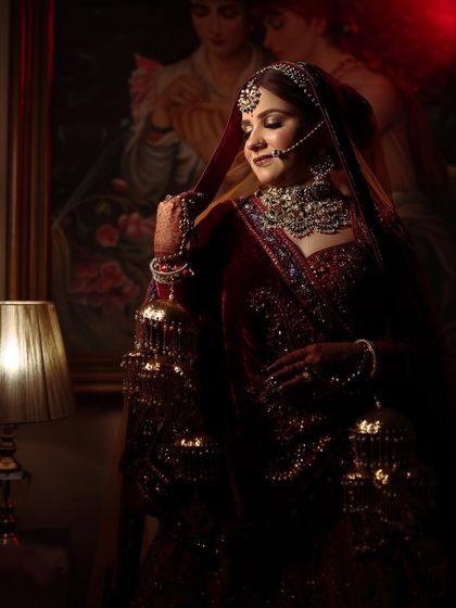A dramatic, low-light shot of the bride, creating a royal and timeless portrait.
