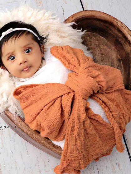 A cute moment with the baby's tongue just peeking out. We capture all their adorable expressions.