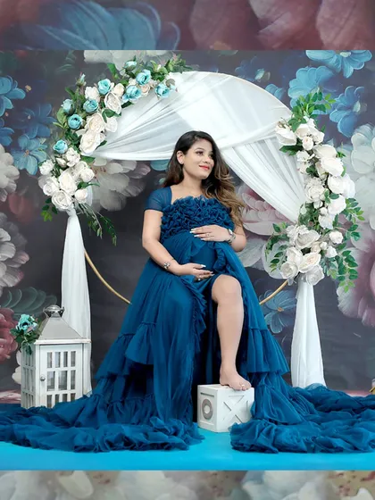 Another angle of this stunning blue gown setup, showing the full floral arch and lantern props that add to the enchanting atmosphere of the shoot.