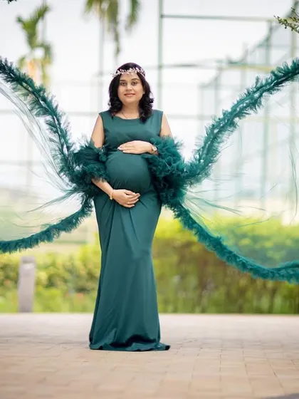 For a touch of drama, I use gowns with unique features like these flowing angel wings. This solo portrait in a deep green gown creates a powerful and unforgettable image for the mom-to-be.