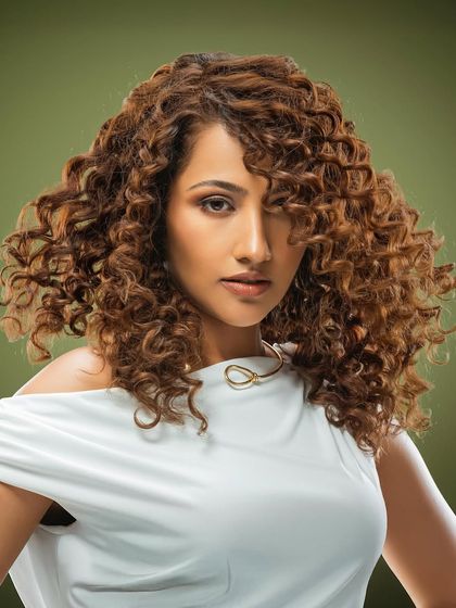 A stunning curly look from our Bespoke Brunette Collection. We specialize in coloring curls to enhance their natural pattern and create beautiful, light-reflecting dimension.