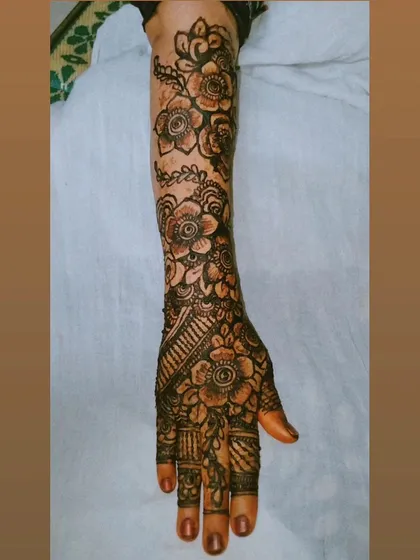 A beautiful, fully developed henna stain on a full-arm floral design. The color is deep and consistent, a result of my all-natural paste and proper aftercare.