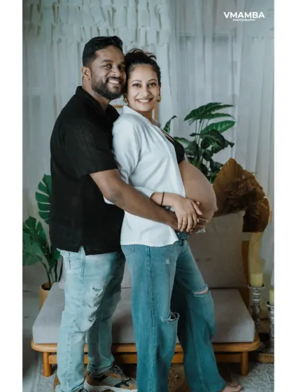 Including your partner in the maternity shoot is a wonderful way to capture your journey together. This pose shows the couple's excitement and love.