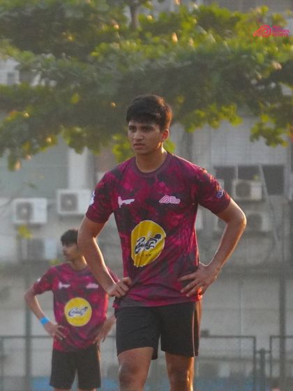 A player stands ready, anticipating the next play with focus and determination.