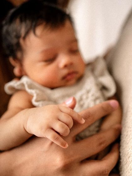 A newborn's tiny hand grasping a parent's finger is a detail worth remembering. I focus on these small yet significant moments that tell the story of your baby's first days.