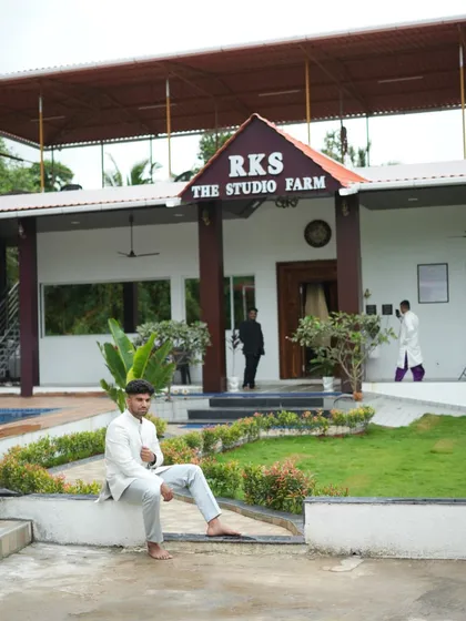 Our client relaxing in the grey Jodhpuri suit at a beautiful farmhouse location. It shows how our rental outfits are perfect for pre-wedding shoots as well.