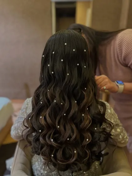 A back view of the soft waves with scattered pearls, a very popular and dreamy hairstyle.