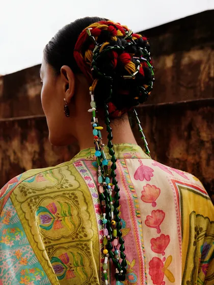 A close-up of the colorful, beaded hairstyle created for the Ani Clothing campaign.