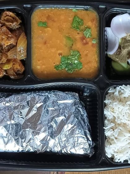 A thali for those who love bitter gourd. This meal features a homestyle karela sabzi with dal tadka, rice, and roti.