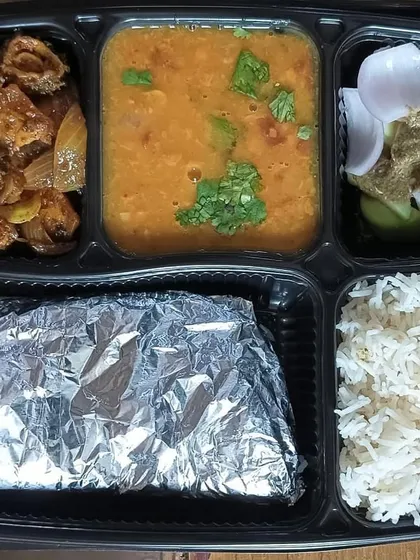 A thali for those who love bitter gourd. This meal features a homestyle karela sabzi with dal tadka, rice, and roti.