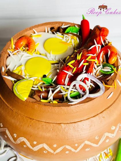 A close-up of the incredible detail on my whipped cream Biryani cake. You can see the texture of the rice, the shine on the fried onions, and the vibrant colors of the chilies, all made from edible materials.