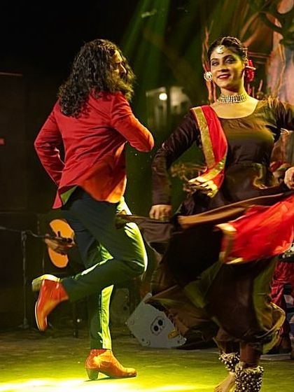 A dynamic shot of a Flamenco-Kathak duet during a wedding performance.