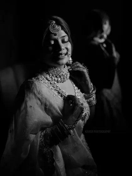A beautiful black and white shot of the bride getting ready, capturing a candid moment of reflection.