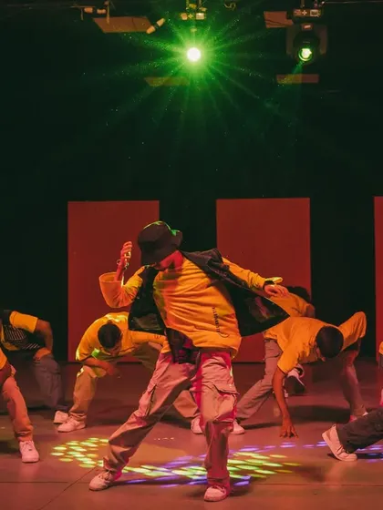 Star vibes during a stage performance at Allstars Night. This shot captures the focus and power of a group hip-hop routine under the bright lights.
