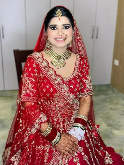 A full-length shot showing the complete bridal ensemble. The makeup was designed to be impactful from a distance yet flawless up close, ensuring she looked perfect in every photo.
