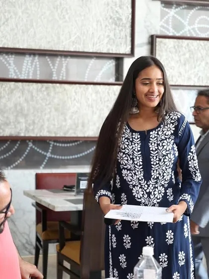 Sharing a smile with participants during a brunch workshop. Creating a friendly and approachable atmosphere is key to helping people feel comfortable, especially beginners.