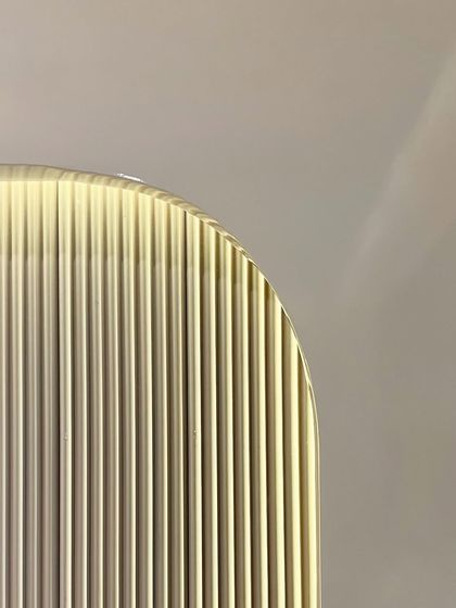 An abstract close-up of a fluted glass panel used in one of our projects. This detail highlights our use of texture and light to add depth and sophistication to our interior designs.