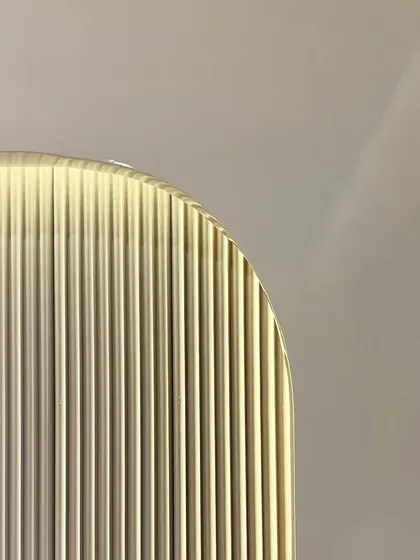 An abstract close-up of a fluted glass panel used in one of our projects. This detail highlights our use of texture and light to add depth and sophistication to our interior designs.