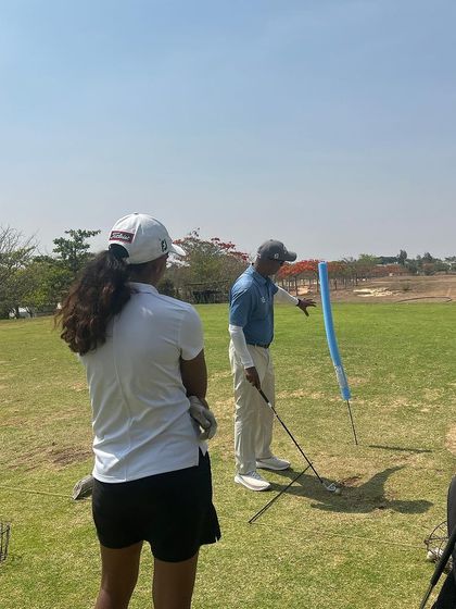 My favorite place to be is out on the course with the players. Here, I am working with a player on her swing, helping her get to the next level.