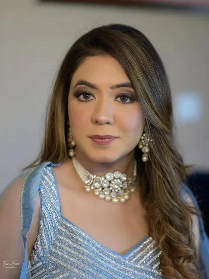 A close-up of the makeup. The smokey eye is soft and blended, and the pearl choker adds a touch of elegance.