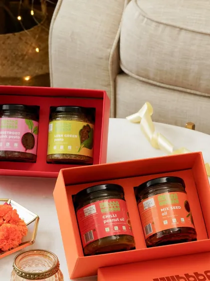 Beautifully packaged gift boxes of healthy pastes and oils, styled for a festive or special occasion.