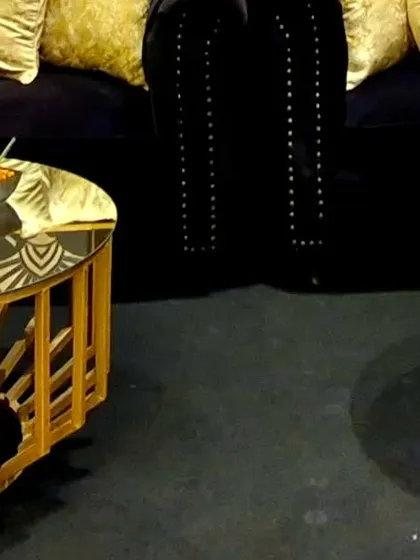 A pair of our custom-designed Art Deco coffee tables, providing a functional and stylish centerpiece for the lounge seating area. The mirrored tops add a touch of glamour and light to the dark, moody color palette.