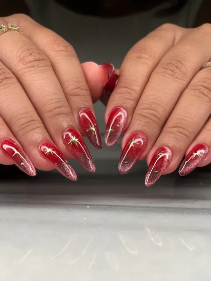 A fiery red cat-eye effect on long coffin nails. I added delicate gold star charms to this set for a touch of celestial magic against the deep, shimmering base.