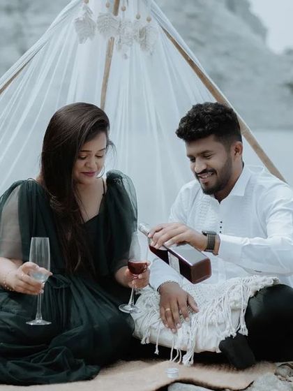 A romantic moment from a styled pre-wedding shoot, with the groom pouring wine for the bride. These details add a touch of elegance and storytelling.