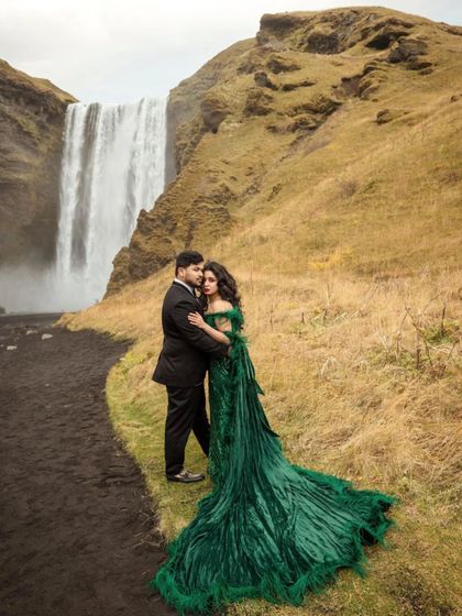 Crafting a couple's look is about harmony. His classic black suit complements her dramatic green gown without competing, ensuring they both look like the stars of their own movie.